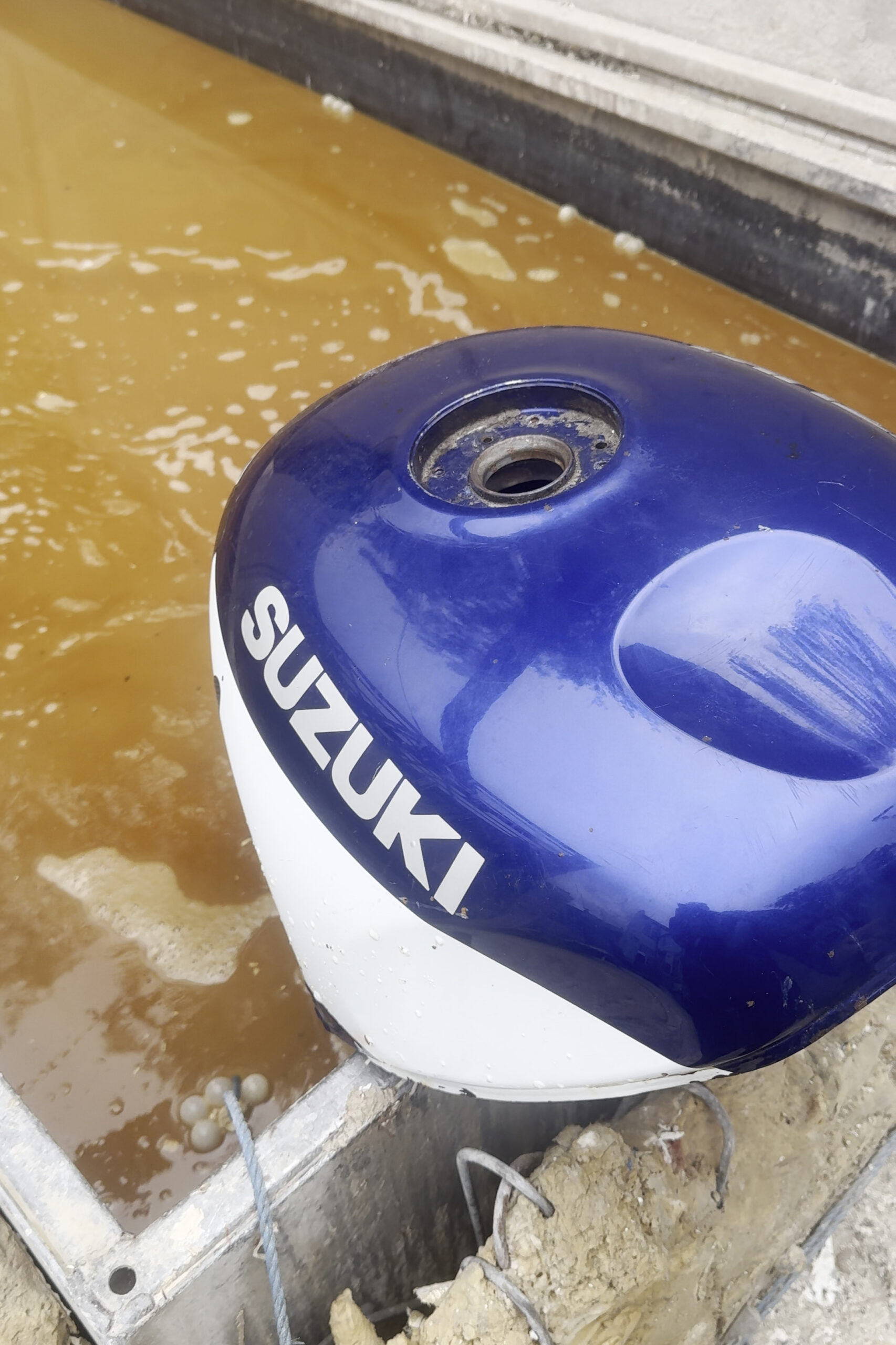 Suzuki GSXR motorcycle fuel tank before stripping