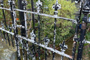 Wrought iron fence before stripping